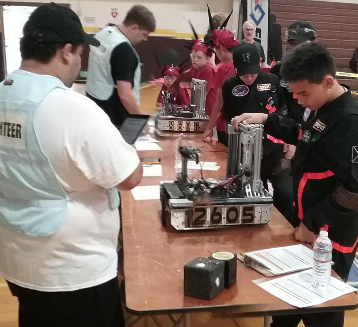Dark Voyager and Intergalactic Dragons teams go through robot inspection.