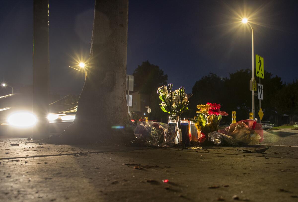 Flowers and candles on the sidewalk