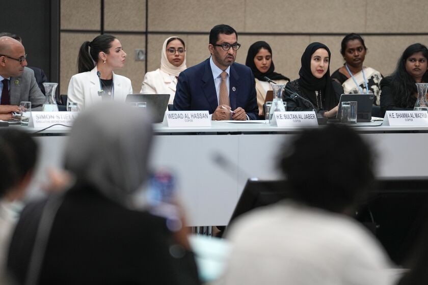 Sultan al-Jaber, center, who will preside over the next UN global climate summit in Dubai, talks to delegates at the United Nations Climate Change Conference in Bonn, Germany, Thursday, June 8, 2023. Al-Jaber said he wants the COP28 summit in Dubai to be "inclusive" and deliver a “game-changing outcome” for international efforts to tackle climate change. (AP Photo/Martin Meissner)