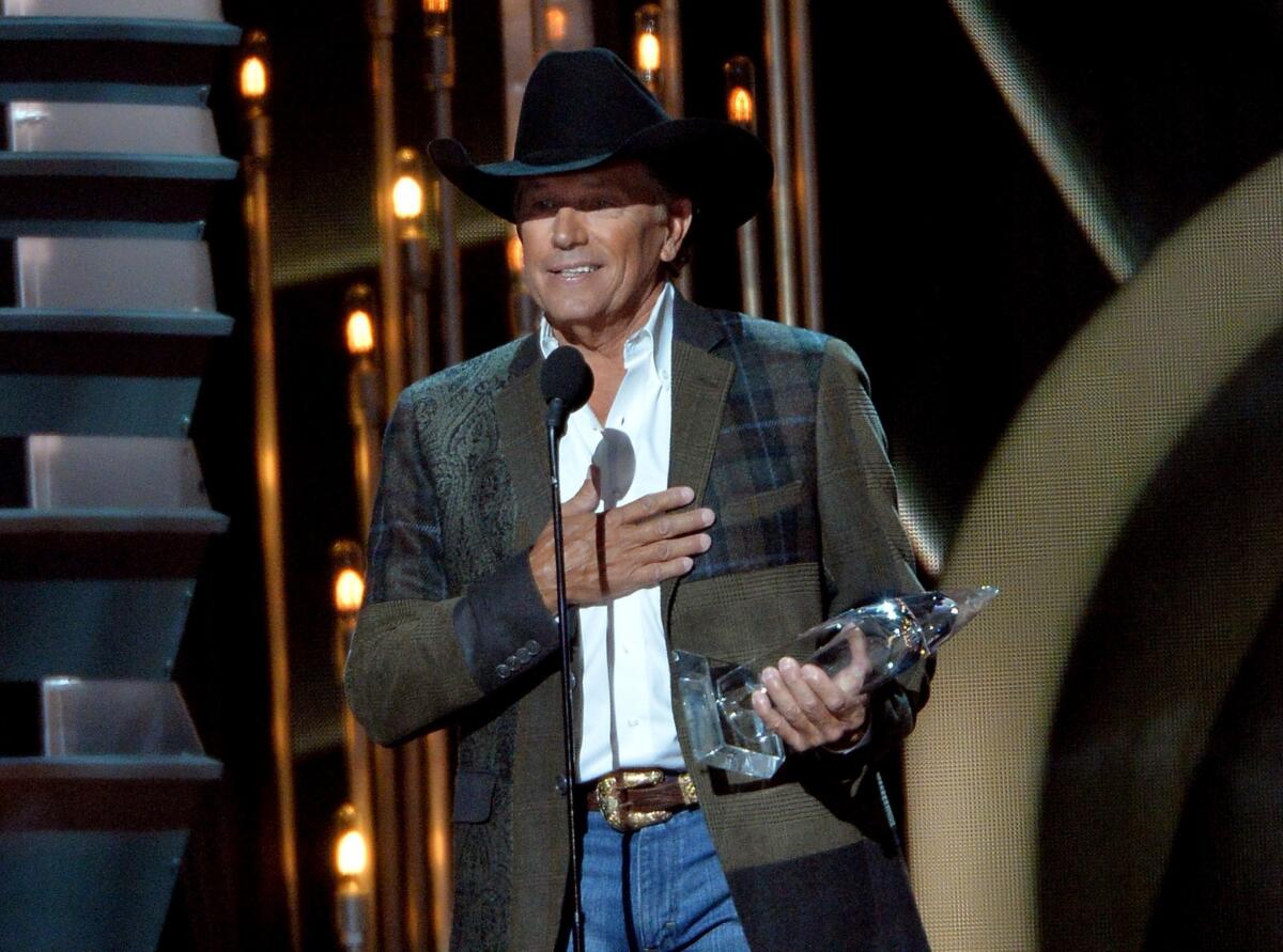 Entertainer of the year winner George Strait speaks during the 47th annual CMA Awards at the Bridgestone Arena in Nashville.