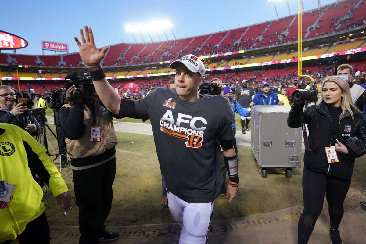 Cincinnati Bengals quarterback Joe Burrow waves to fans as he walks off the field after the AFC championship NFL football game against the Kansas City Chiefs, Sunday, Jan. 30, 2022, in Kansas City, Mo. The Bengals won 27-24 in overtime. (AP Photo/Paul Sancya)