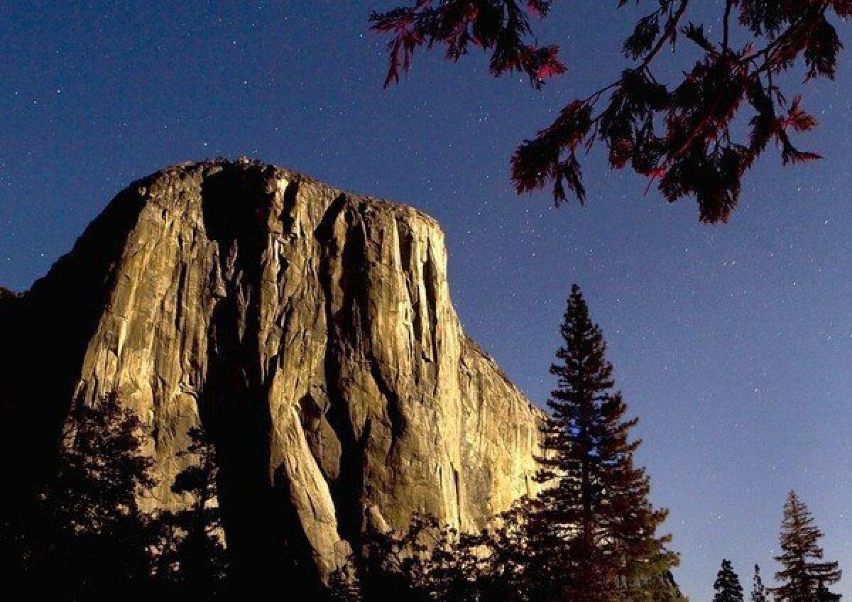 El Capitan is shown on a moonlit night. A man climbing the massive formation was killed Sunday when he was struck by a falling rock.