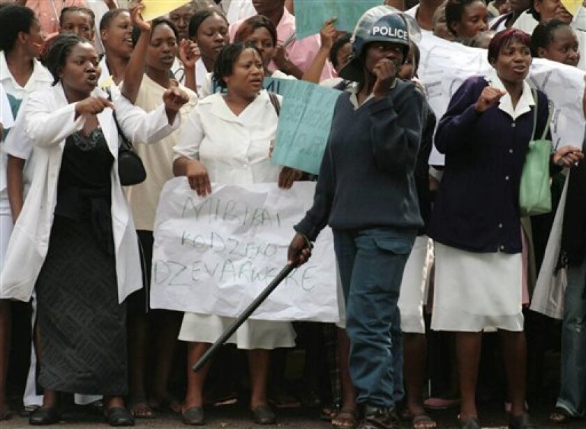 Health workers picket outside the Parirenyatwa hospital in Harare, Tuesday Nov. 18, 2008, where doctors and nurses were protesting for better working conditions and salaries. amid Zimbabwe's collapsing health system. The protesters planned to present a petition to the government calling for "urgent action" to address the crisis in the public health system. Their grievances include a lack of medical supplies, equipment and drugs, leaving poor Zimbabweans unable to access proper care. Zimbabwe faces chronic shortages of food, fuel and basic foods which impacts on the health system(AP Photo)