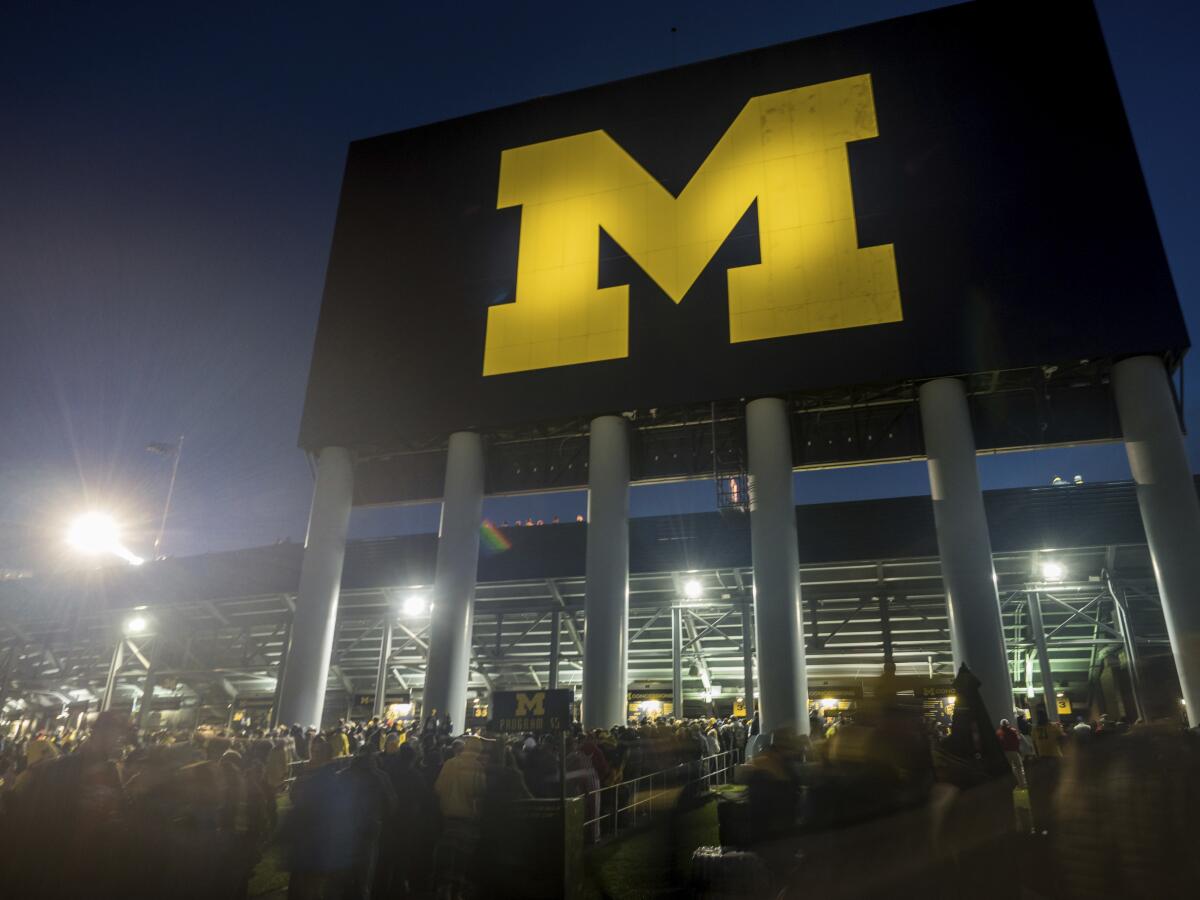 Fans walk outside Michigan Stadium under the north scoreboard before Michigan's game against Wisconsin on Oct. 13, 2018.