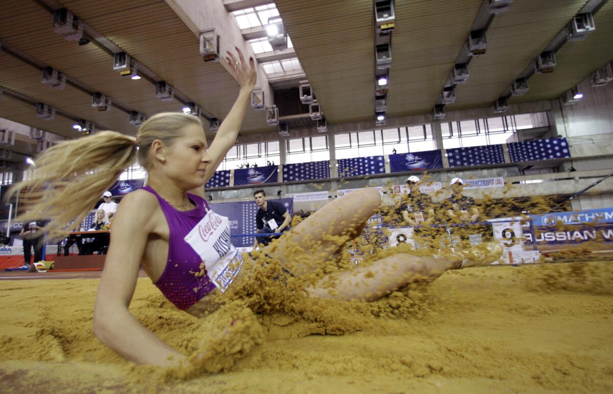 Russia's Daria Klishina lands in the sand during a long jump event on Feb. 6, 2011.