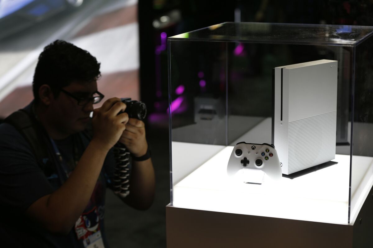 A photographer gets a view of the new Microsoft Xbox One S game console.