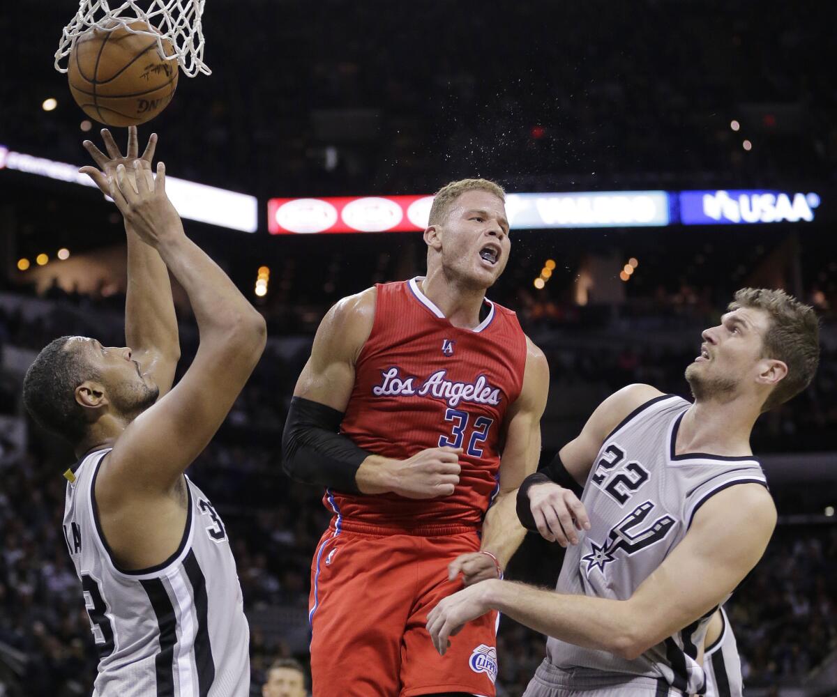 Clippers forward Blake Griffin reacts after scoring against Spurs forward Boris Diaw (33) and center Tiago Splitter (22) in the first half.
