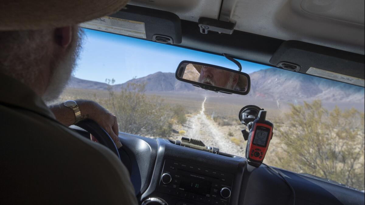 Mark Meyers, founder of Peaceful Valley Donkey Rescue, drives a Jeep on Butte Valley Road to help set up burro capture pens in a remote pocket of Death Valley National Park.
