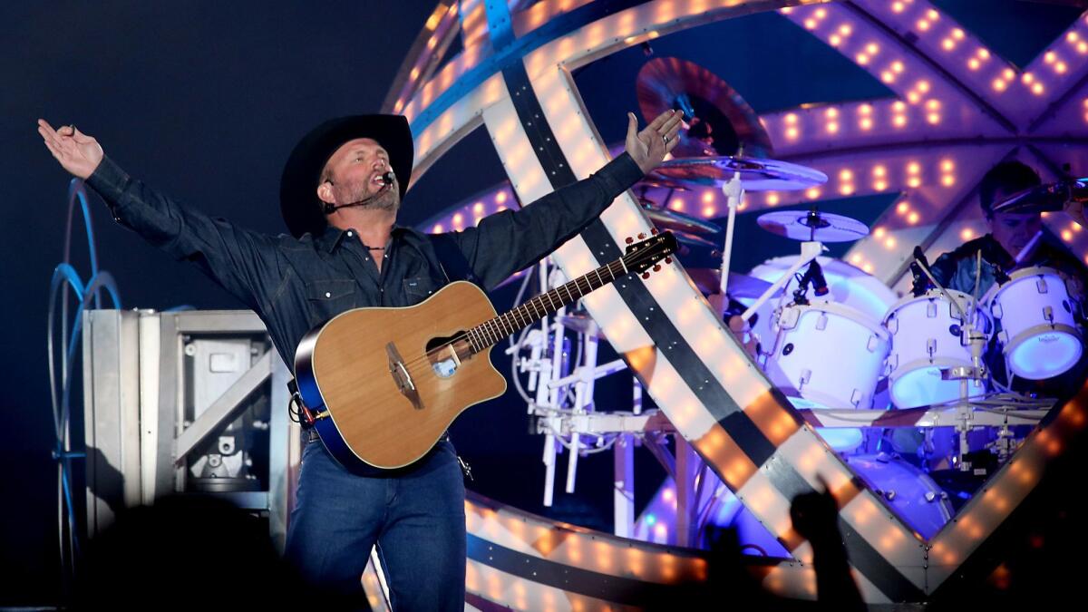 Country music superstar Garth Brooks, shown performing in July at the Forum in Inglewood, has topped sales charts again with his latest release, "Anthology," a combination autobiography and CD box set.
