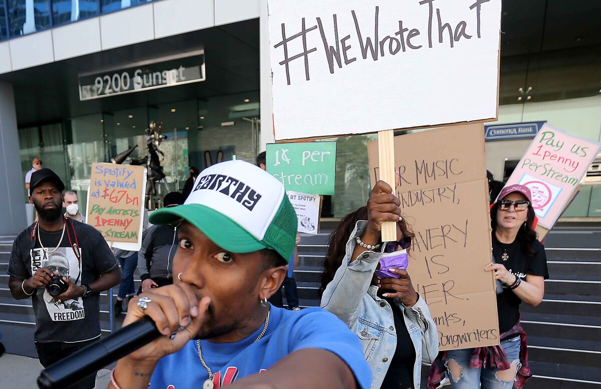 Songwriters take to the streets to protest Spotify payments - Los ...