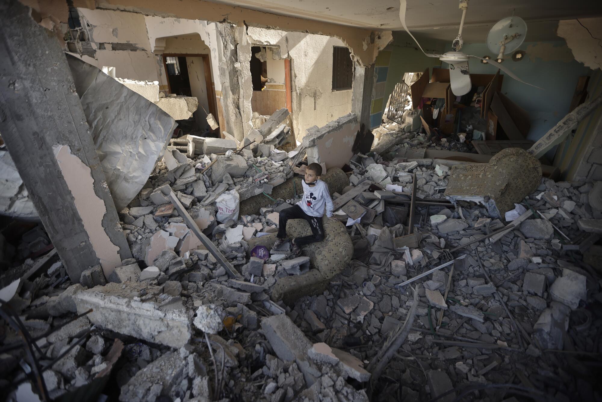Palestinians inspecting their destroyed homes in Khan Yunis, Gaza