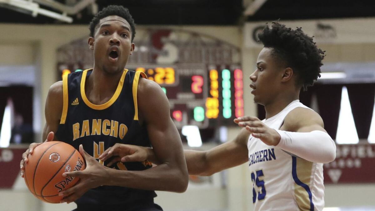 Rancho Christian's Evan Mobley, left, takes on McEachern's Isaac Okoro on Jan. 21 in Springfield, Mass.