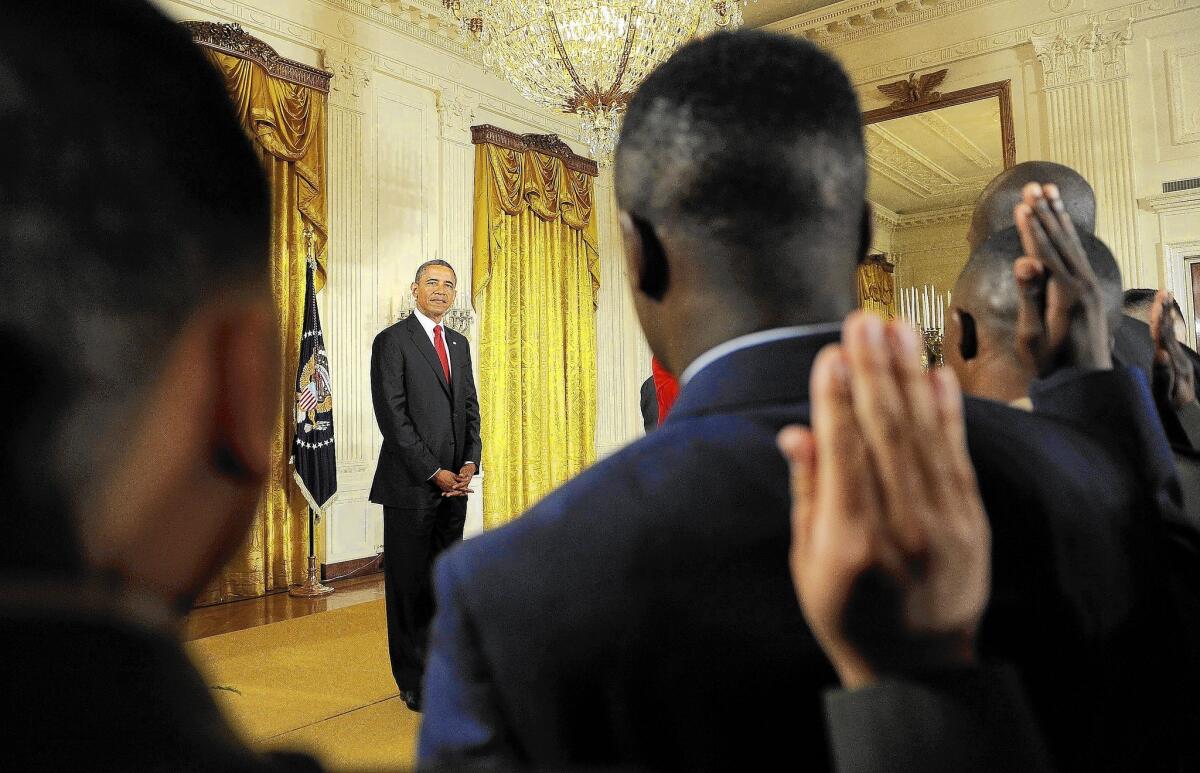 President Obama listens at the White House naturalization ceremony for active-duty service members on July 4, 2012.