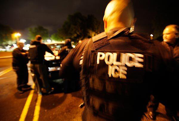 Immigration and Customs Enforcement agents gather before sunrise in the parking lot of a sheriff's station in the Santa Clarita Valley. See full story