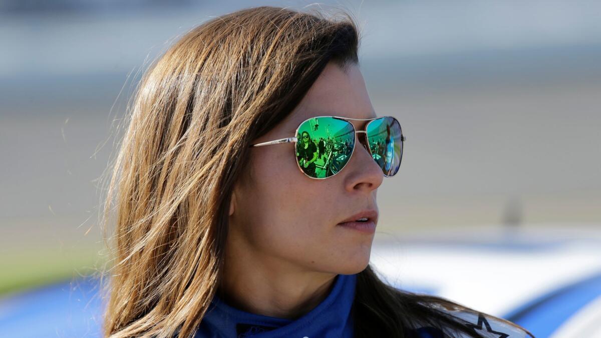Danica Patrick stands on pit road after a qualifying run for the NASCAR Daytona 500 on Feb. 19.