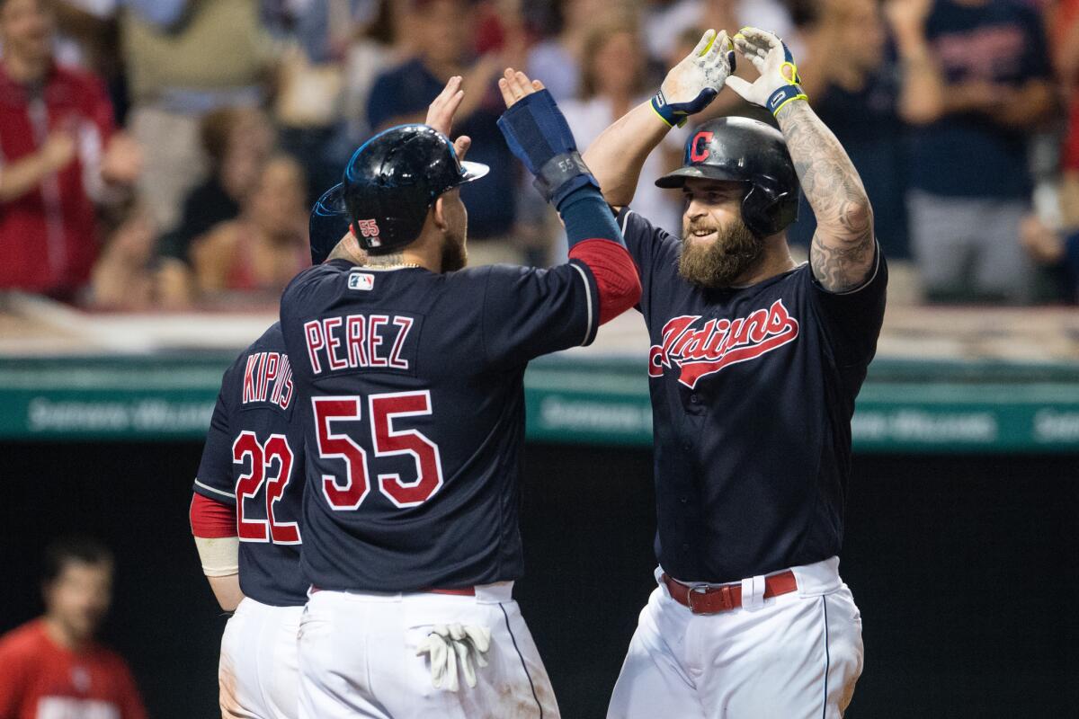 Indians slugger Mike Napoli (26) is congratulated by teammates Jason Kipnis (22) and Roberto Perez (55) after his three-run home run against the Angels on Aug. 11.
