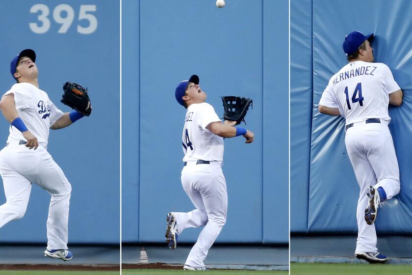 Dodgers center fielder Enrique Hernandez tracks down a deep fly ball hit by Colorado's Michael McHenry in the fourth inning Saturday night.