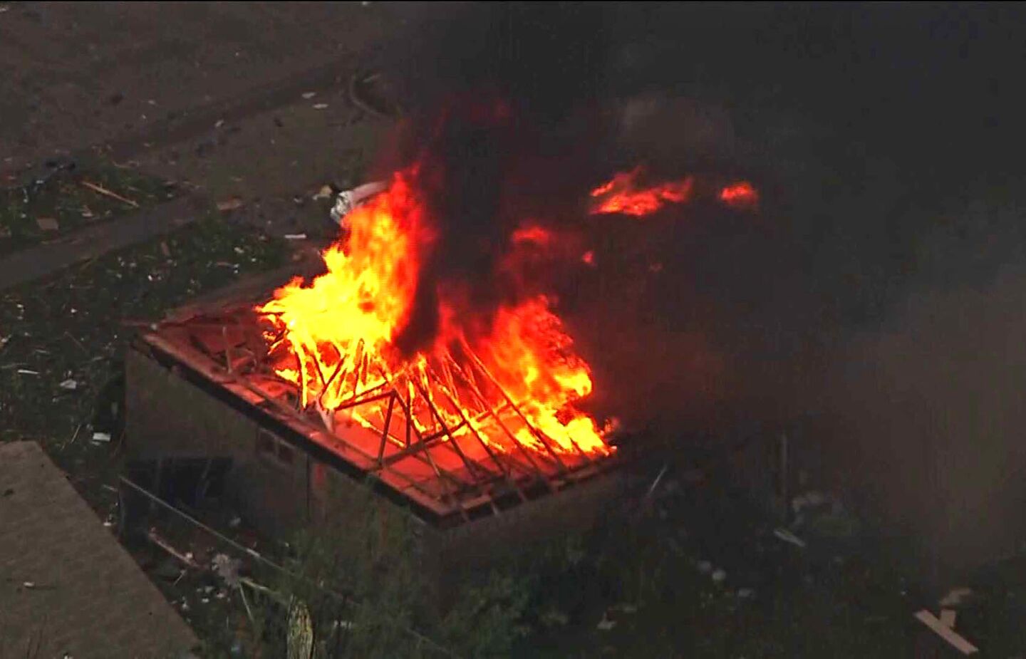 This photo provided by KFOR-TV shows a house fire outside Moore, after tornado as much as a mile wide roared through the Oklahoma City suburbs, flattening neighborhoods, leaving buildings ablaze landing a direct blow on an elementary school.
