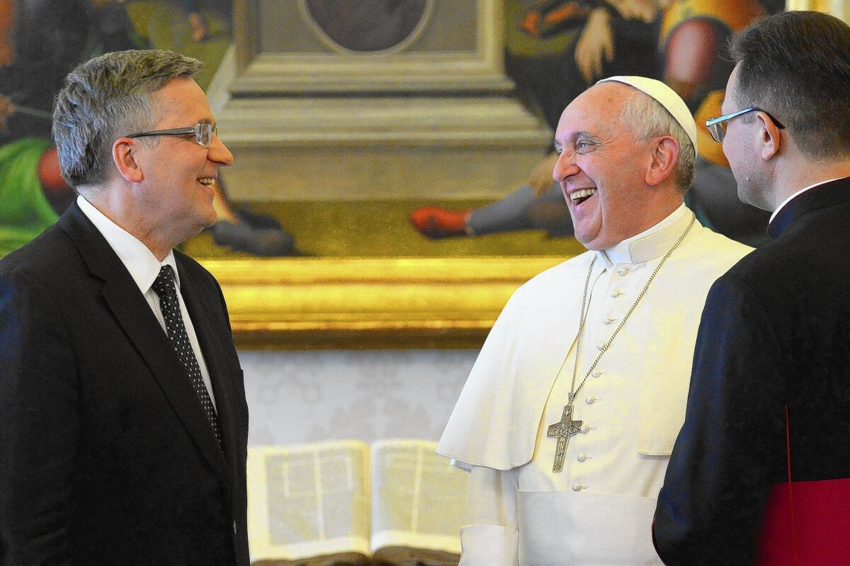 Pope Francis meets with Polish President Bronislaw Komorowski, left, at the Vatican. On the pontiff's orders, the Vatican will convene a meeting of senior clerics this fall to reexamine church teachings that touch the most intimate aspects of people's lives.