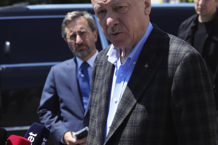 In this photo made available by the Turkish Presidency, Turkish President Recep Tayyip Erdogan speaks to the media after Friday prayers, in Istanbul, Turkey, Friday, May 13, 2022. Erdogan said Friday that his country is "not favorable" toward Finland and Sweden joining NATO, indicating that Turkey could use its status as a member of the Western military alliance to veto moves to admit the two countries. (Turkish Presidency via AP)