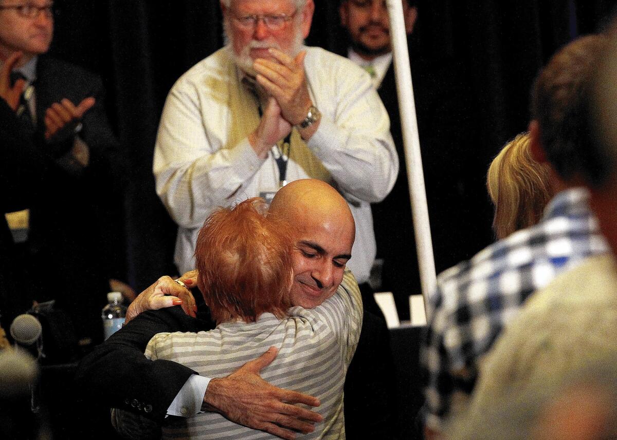 Republican gubernatorial candidate Neel Kashkari is greeted by a supporter after delivering a speech to delegates at the California Republican Convention at the LAX Marriott.
