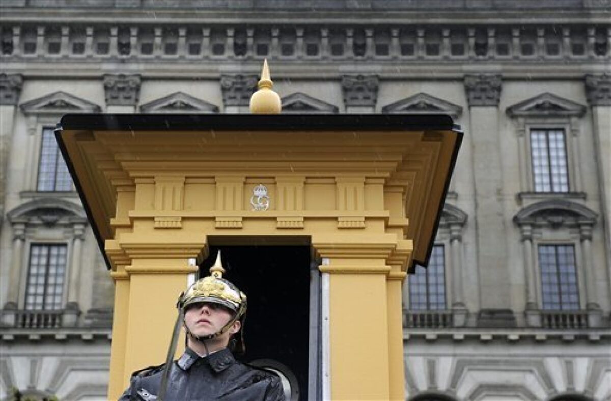 A guard stands in the rain outside the Royal Palace in Stockholm Friday June 11, 2010. Preparations taking place around Stockholm prior to the royal wedding of Crown Princess Victoria and Daniel Westling scheduled for next weekend. (AP Photo/Anders Wiklund)