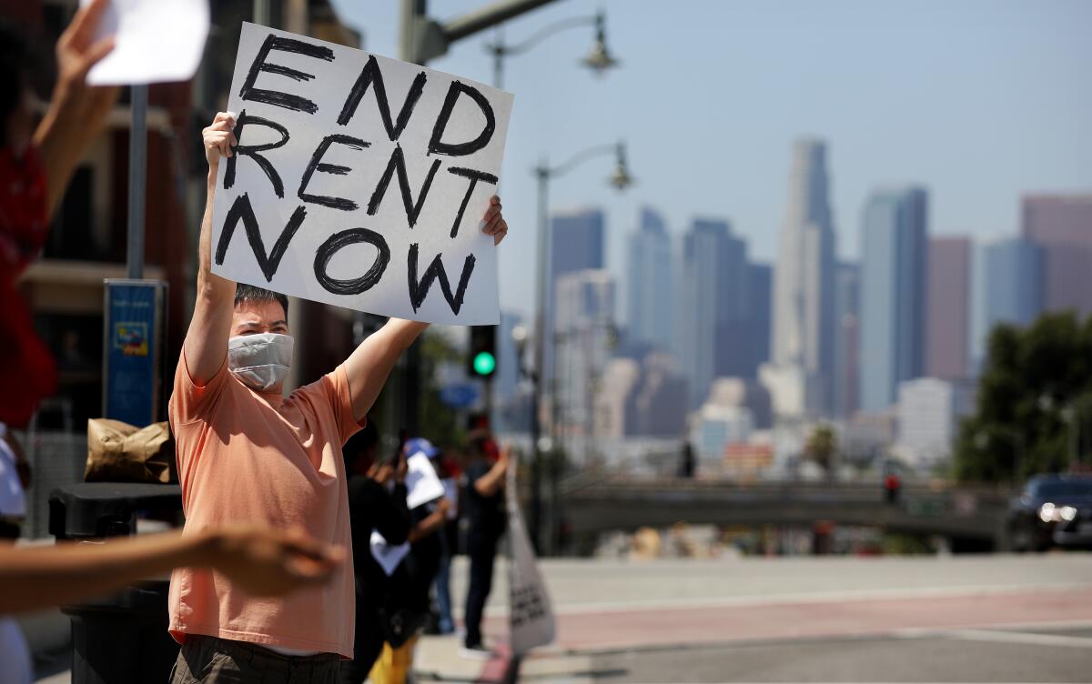 Noah, who declined to give his last name, participates in a demonstration with members of the Los Angeles Tenants Union and their supporters at Mariachi Plaza in Boyle Heights recently.