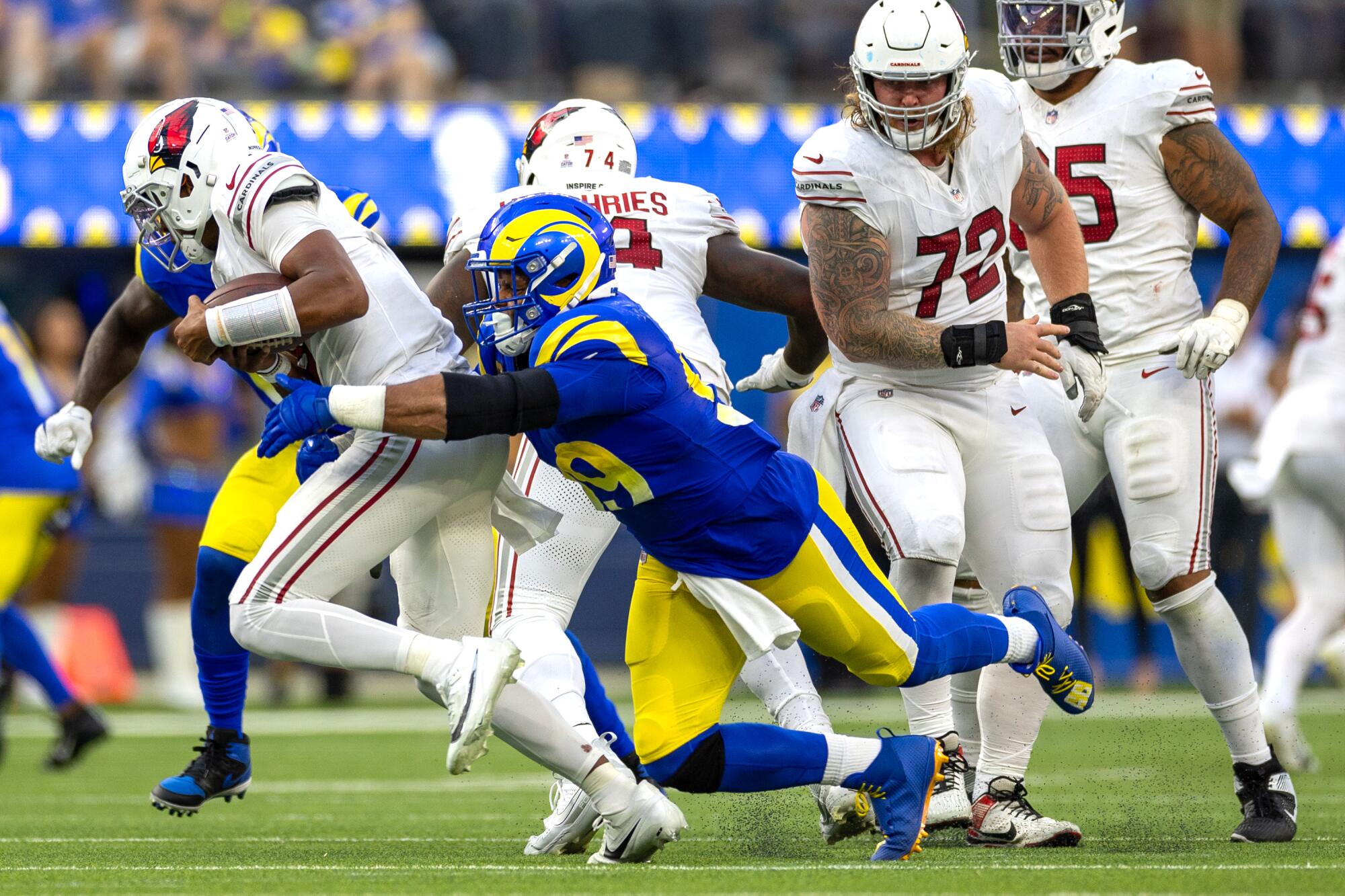 Rams defensive tackle Aaron Donald tackles Arizona Cardinals quarterback Joshua Dobbs.