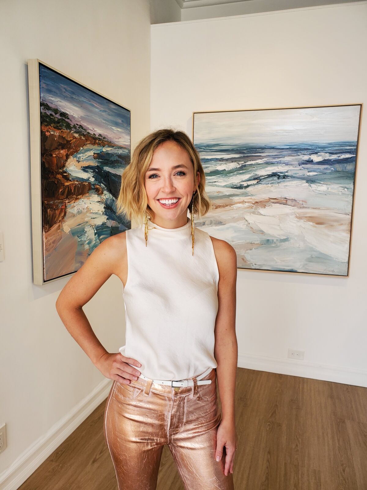 Krista Schumacher stands in her pop-up gallery on Wall Street in La Jolla.