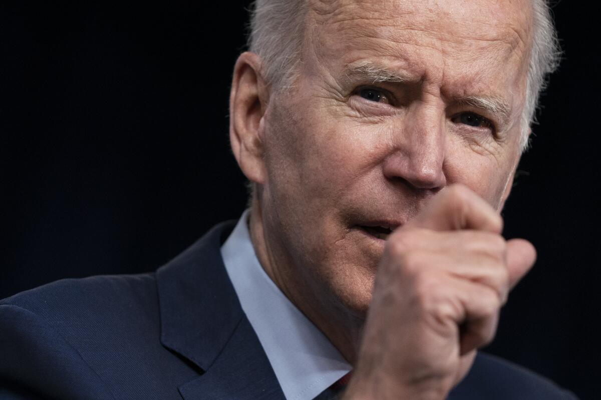 A closeup of President Biden gesturing as he speaks