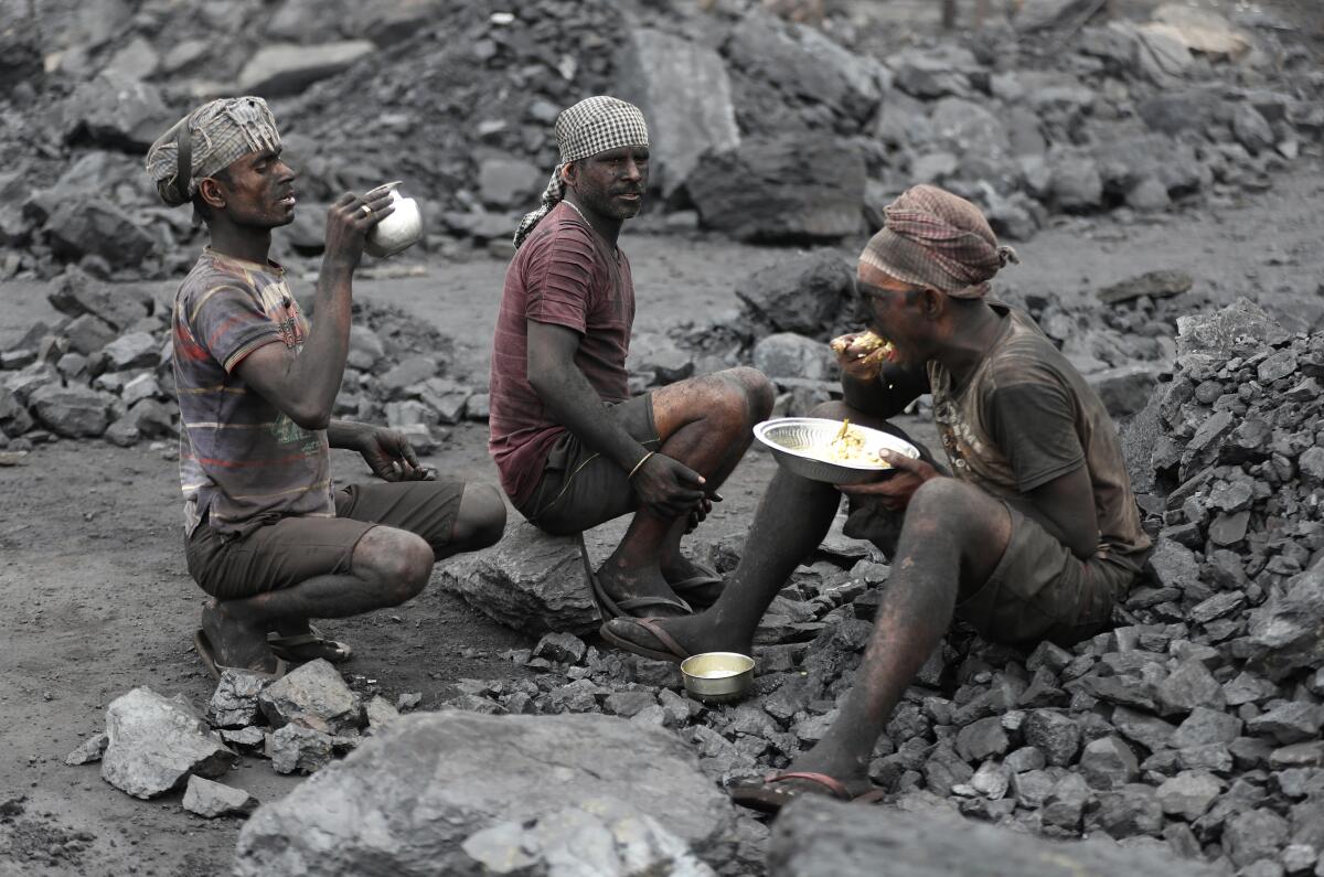 Workers lunching at a coal loading site