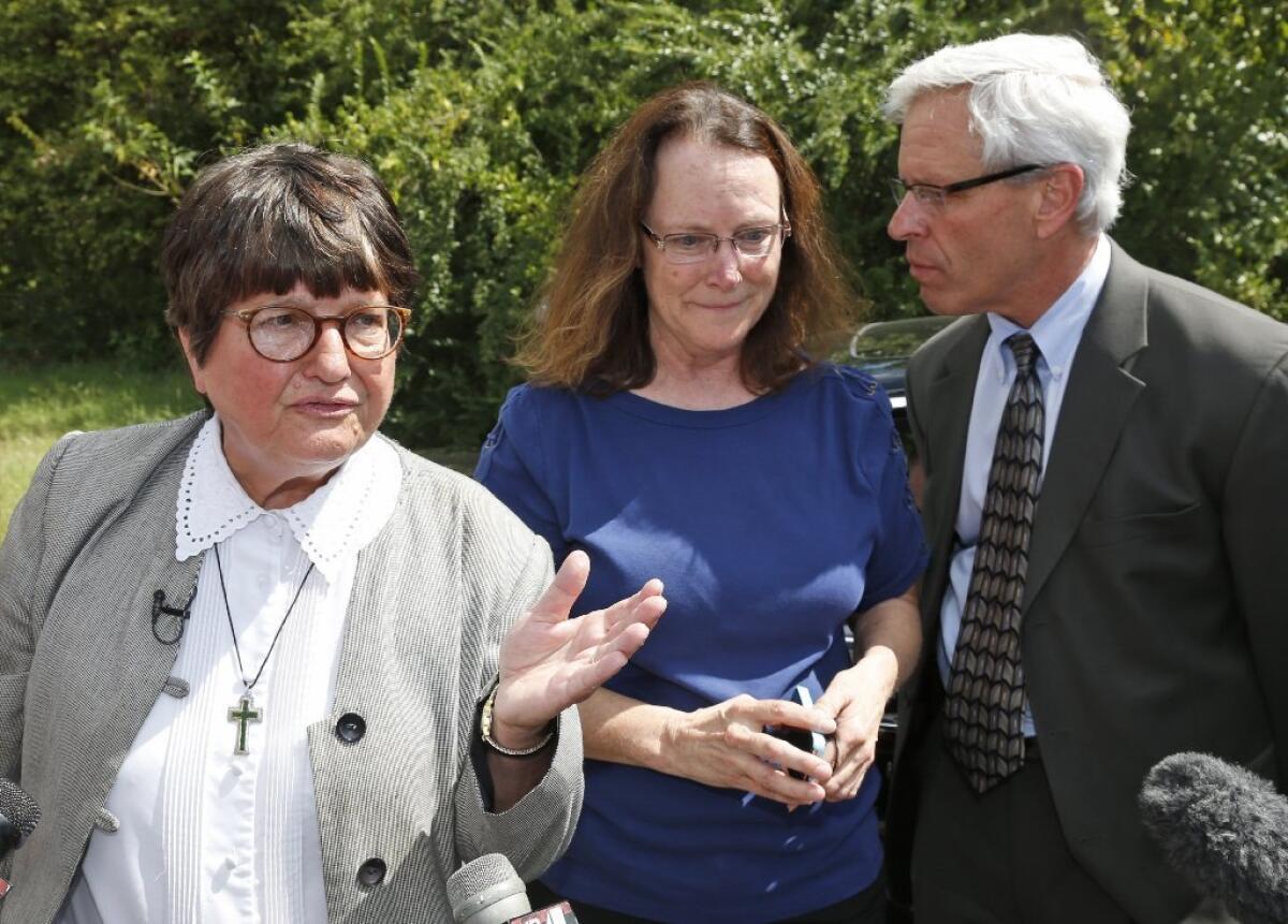 Sister Helen Prejean, left, addresses the media outside the Oklahoma State Penitentiary about the case of death row inmate Richard Glossip. With her are two of Glossip's attorneys, Kathleen Lord and Don Knight.