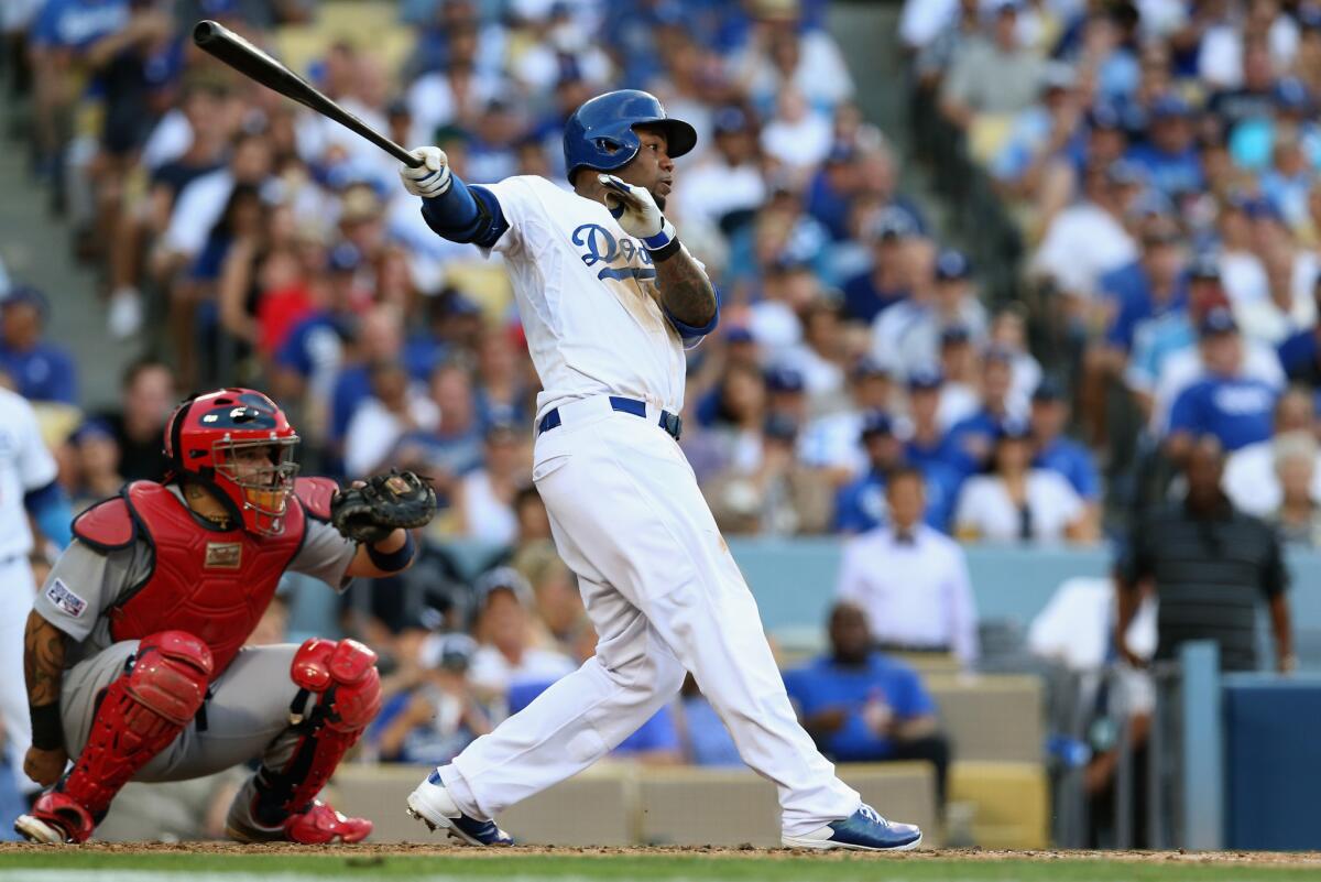Left fielder Carl Crawford singles against the St. Louis Cardinals in the first game of the National League division series at Dodger Stadium.