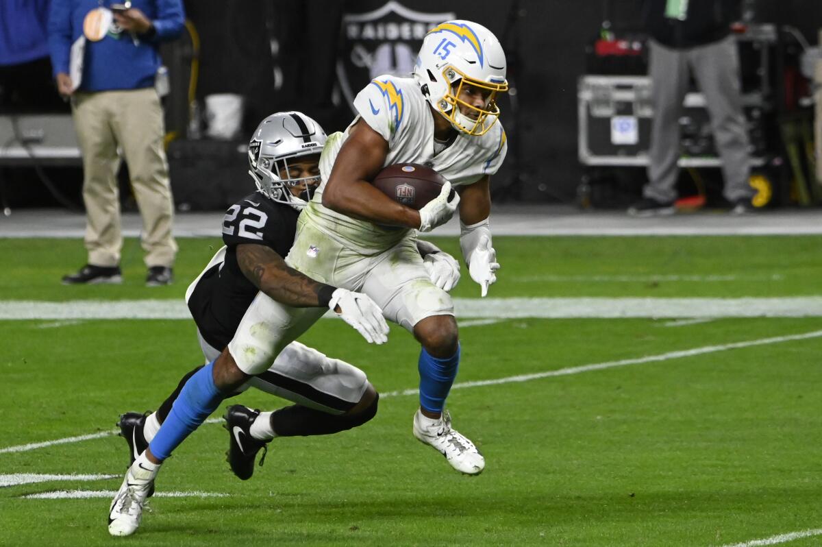 Chargers wide receiver Jalen Guyton is tackled by Las Vegas Raiders cornerback Keisean Nixon.