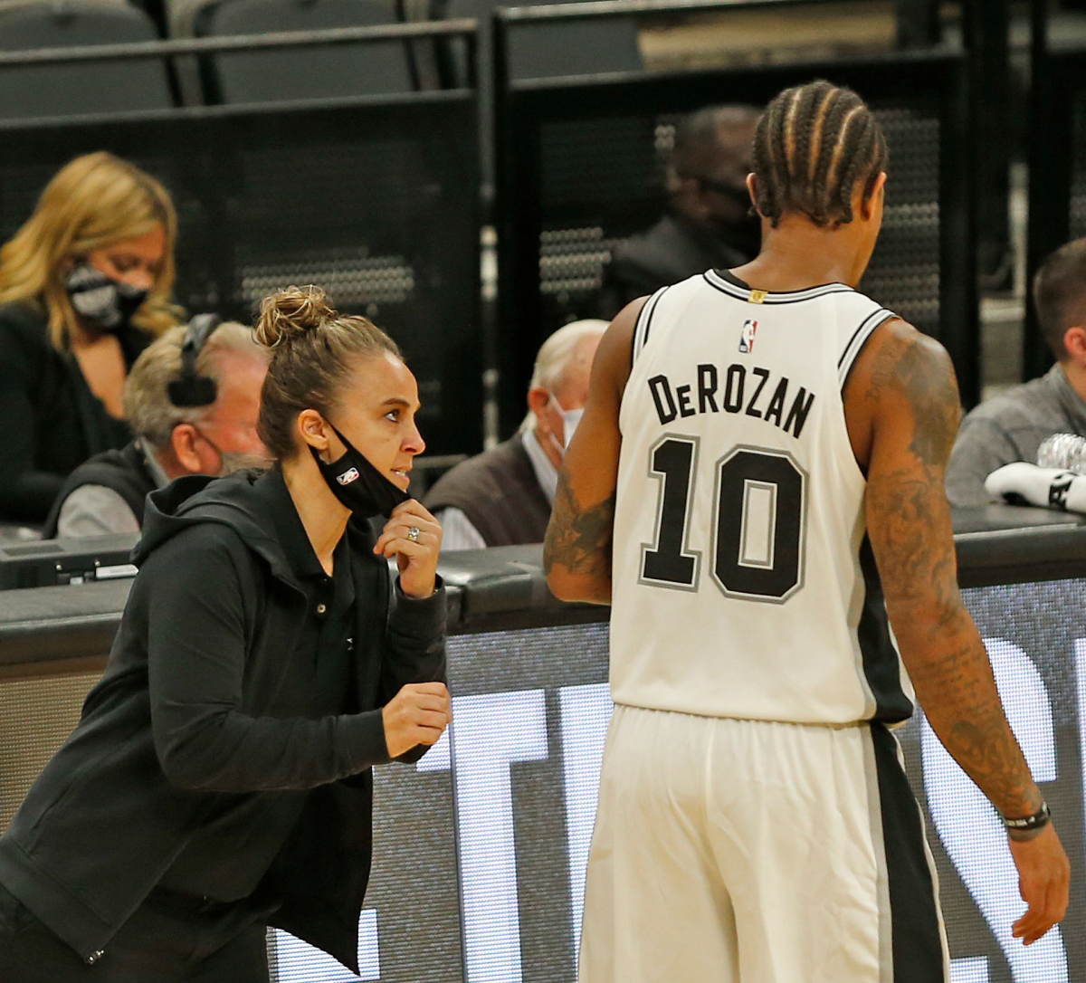 DeMar DeRozan receives instruction from San Antonio Spurs assistant coach Becky Hammon.