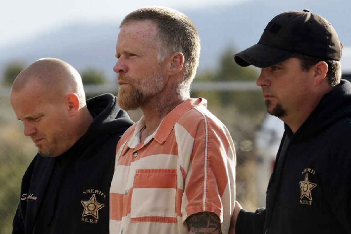 Sanpete Sheriff's Officers escort Troy James Knapp, 45, to the Sanpete County Jail on Tuesday in Manti, Utah.