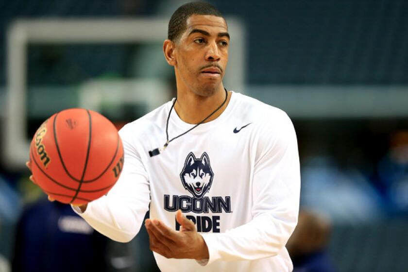 Connecticut Coach Kevin Ollie takes the Huskies through a practice in preparation for the Final Four.