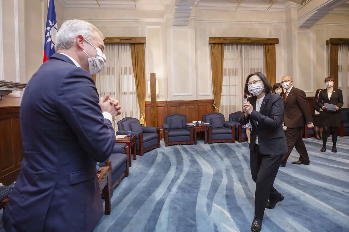 In this photo released by the Taiwan Presidential Office, Taiwan president Tsai Ing-wen, right, greets Francois de Rugy, the head of the Taiwan Friendship group in the National Assembly, the lower house of France's Parliament, during a visit at the Presidential Office in Taipei, Taiwan, Dec. 16, 2021. Rugy is leading a team of French lawmakers from the French National Assembly on a five-day visit to Taiwan. (Taiwan Presidential Office via AP)