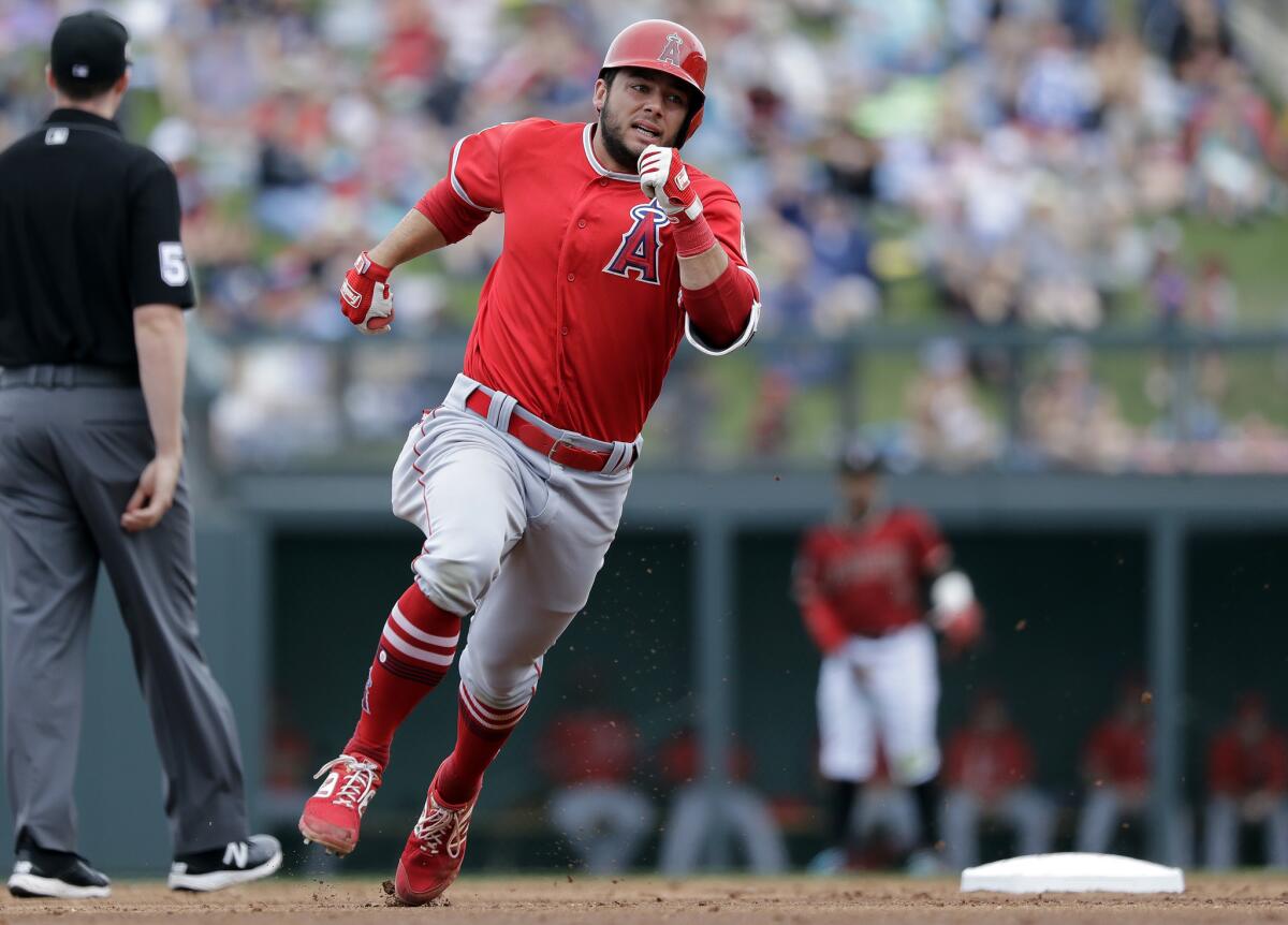 Angels' David Fletcher races toward third base before being sent back on what was ruled a ground rule double against the Arizona Diamondbacks in the third inning of a spring training game on Thursday in Scottsdale, Ariz.