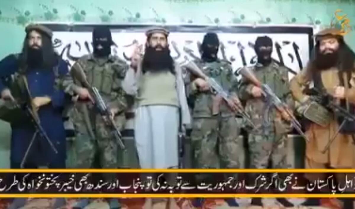 This still image taken from a video released by a Pakistani Taliban faction on Jan. 22 shows its leader Umar Mansoor, center, delivering a statement from an undisclosed location.