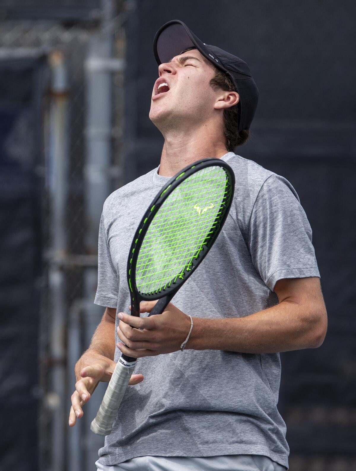 Joseph Emerson of Whittier reacts after losing a point to Daniel Day of Laguna Beach in the boys' 18-and-under round of 64 singles match at the USTA Southern California Junior Sectional Championships in Fountain Valley on Wednesday.