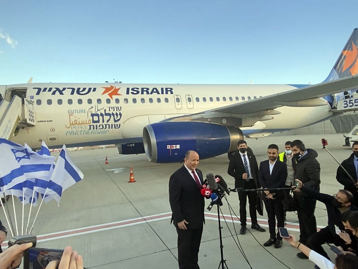 Israeli Prime Minister Naftali Bennett speaks to reporters on the tarmac at Ben Gurion Airport before departing for an official visit to Bahrain, in Lod, Israel, Monday, Feb. 14, 2022. Bennett's trip Monday cements ties between the new allies in a clear message of cooperation to regional archrival Iran and is the first public visit by an Israeli leader to Bahrain. (AP Photo/Ilan Ben Zion)