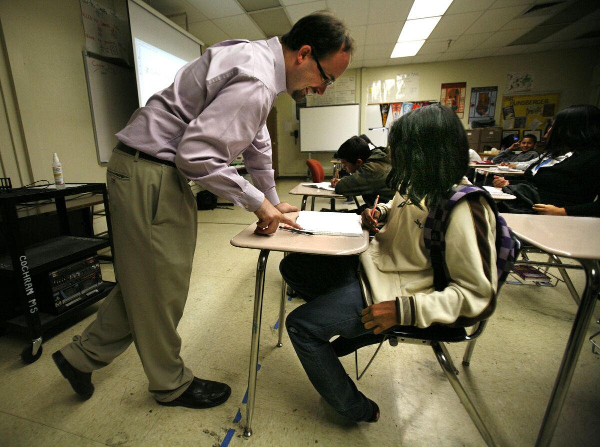 Kyle Hunsberger explains a problem as he teaches his pre-algebra Math 7 class at Johnny Cochran Middle School. Hunsberger was a willing participant in the district's controversial teacher evaluation program, which uses testing data as one measure of how well teachers help students learn.
