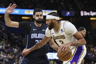 Los Angeles Lakers forward Anthony Davis (3) drives while defended by Orlando Magic center Goga Bitadze (35) during the first half of an NBA basketball game Saturday, Nov. 4, 2023, in Orlando, Fla. (AP Photo/Gary McCullough)