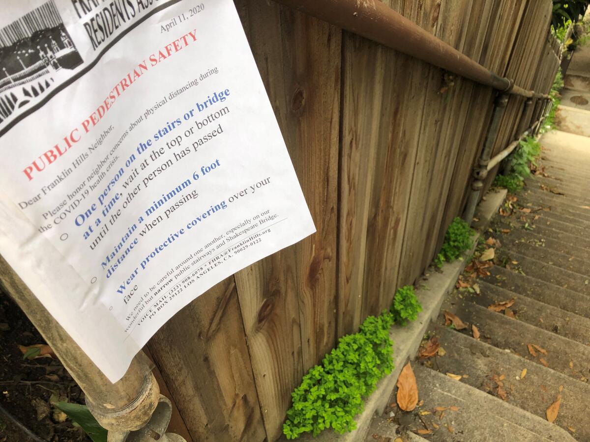 Neighborhood signs in the Franklin Hills area of Los Feliz urge walks to take stairwells one person at a time.