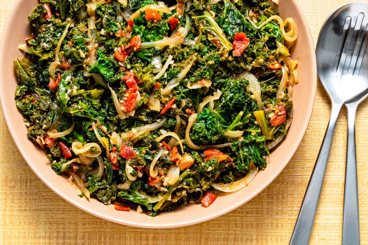 A dish of braised kale and tomatoes.