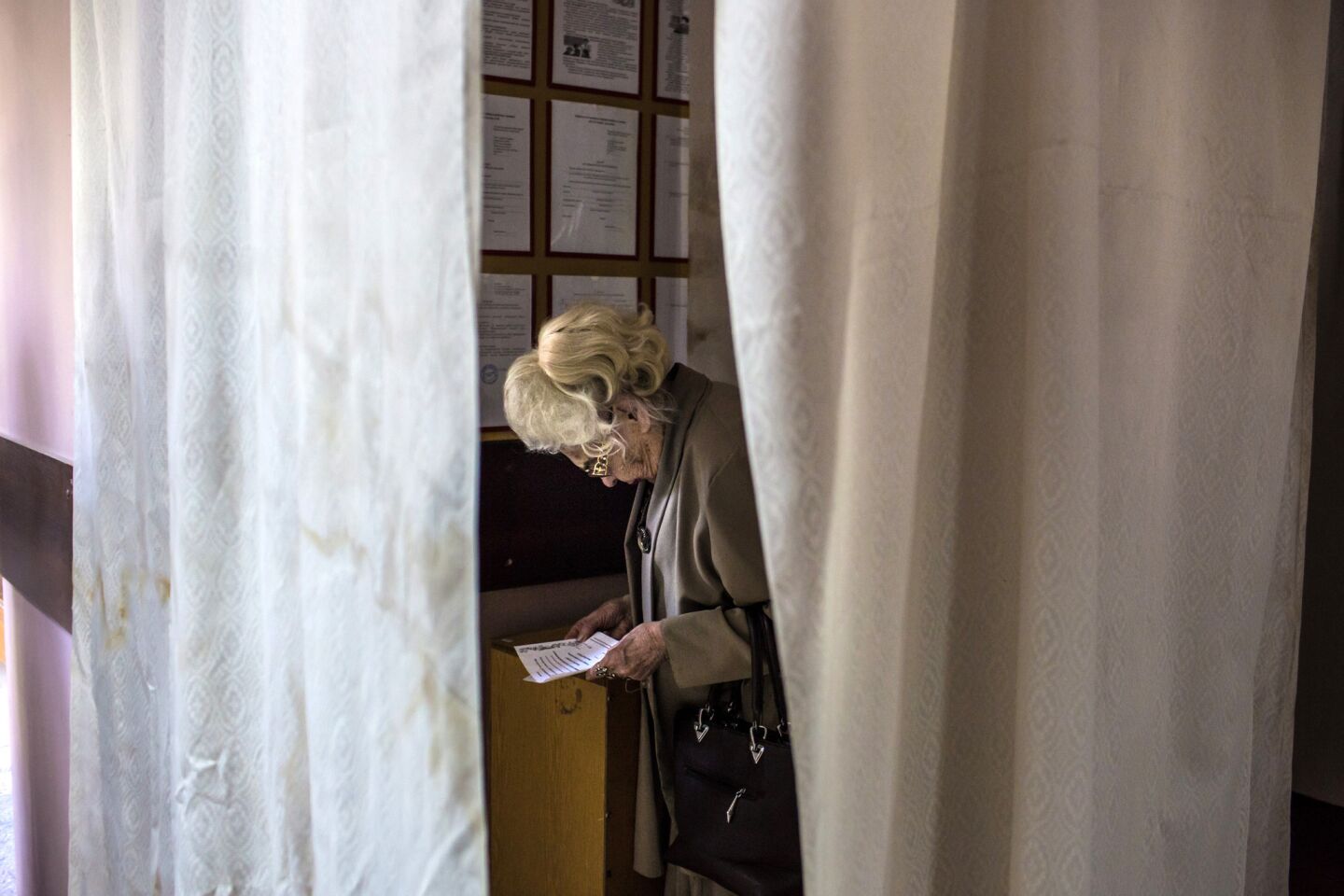 A woman examines her ballot at a polling station in Mariupol, Ukraine, on May 11 during a referendum on greater autonomy for eastern Ukraine.