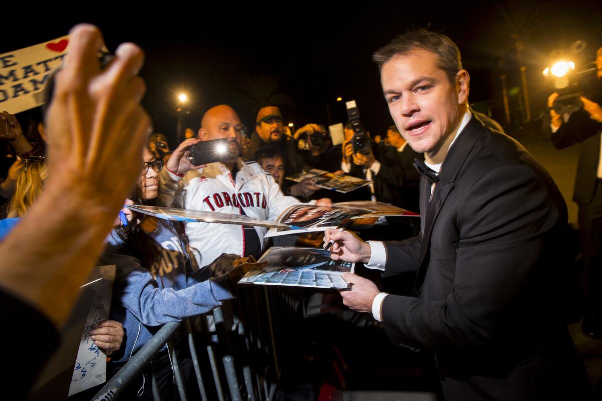 Actor Matt Damon signs autographs before walking the red carpet of the 2015 Palm Springs International Film Festival Awards Gala on Jan. 2, 2016.