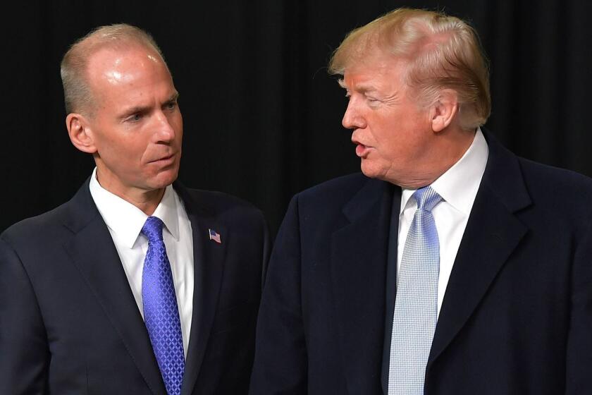 (FILES) In this file photo taken on March 14, 2018, US President Donald Trump speaks with Boeing CEO Dennis Muilenburg (2L) during a tour of the Boeing Company in St. Louis, Missouri. - Trump spoke with Muilenburg on March 12, 2019, about the crash of a 737 MAX 8 aircraft that killed 157 people, an industry source told AFP. The telephone call took place after Trump sent a tweet earlier in the day that said: "Airplanes are becoming far too complex to fly. Muilenburg assured Trump that the aircraft is safe and reliable, the source said. The source declined to say who initiated the phone call or how long it lasted. Boeing would not comment on the call. (Photo by MANDEL NGAN / AFP)MANDEL NGAN/AFP/Getty Images ** OUTS - ELSENT, FPG, CM - OUTS * NM, PH, VA if sourced by CT, LA or MoD **