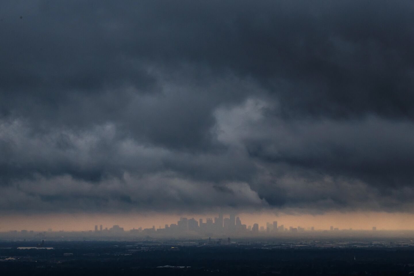 Storm clouds over Houston skyline.